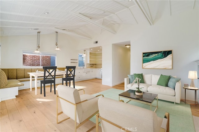 living room with wood ceiling, lofted ceiling with beams, and light hardwood / wood-style floors