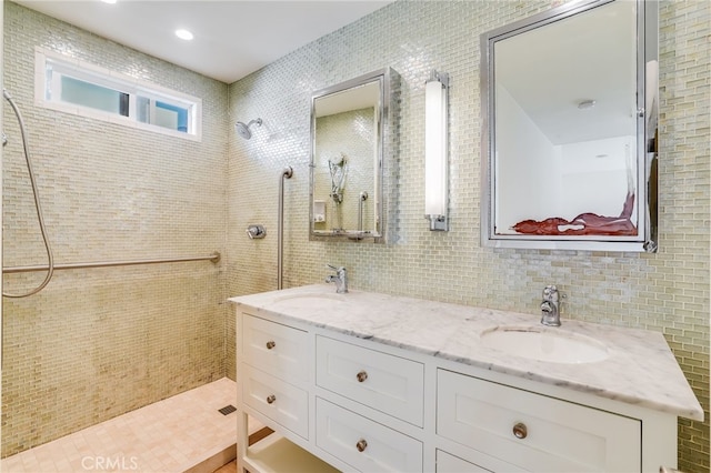 bathroom with vanity, tile walls, and walk in shower