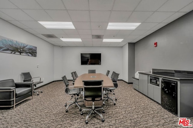 carpeted home office featuring a paneled ceiling