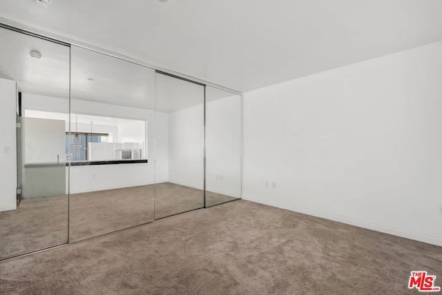 unfurnished bedroom featuring a closet and carpet