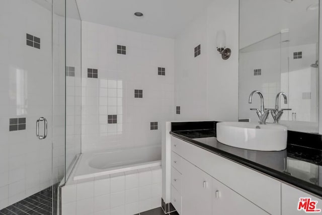 bathroom featuring independent shower and bath and large vanity