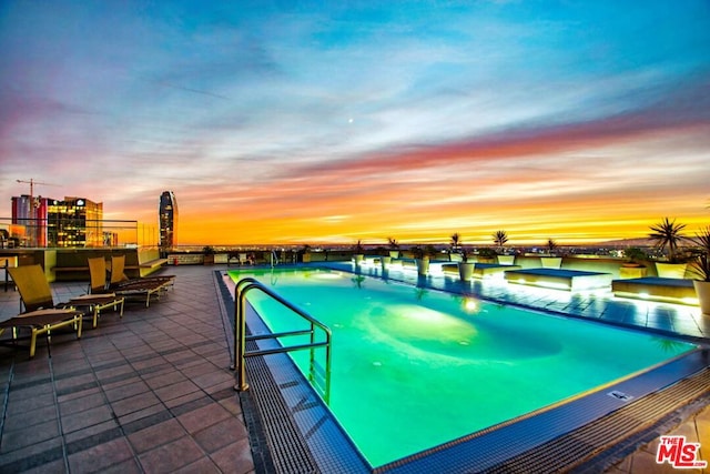 view of pool at dusk