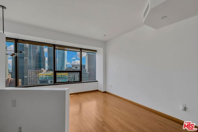 spare room featuring light hardwood / wood-style floors