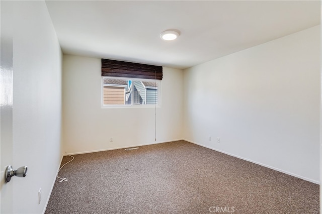 spare room featuring carpet floors