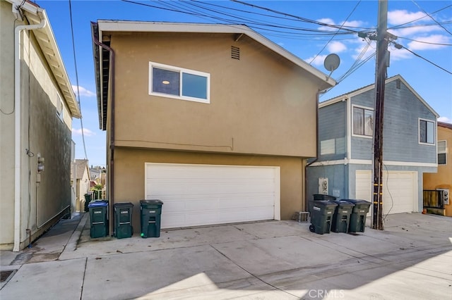 rear view of property with a garage