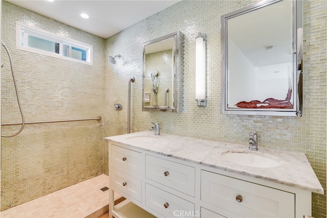 bathroom with vanity, a shower, and tile walls