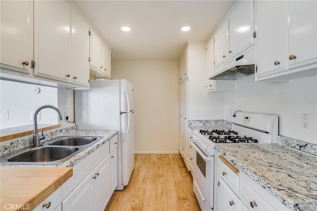 kitchen with white appliances, light hardwood / wood-style flooring, white cabinetry, and sink