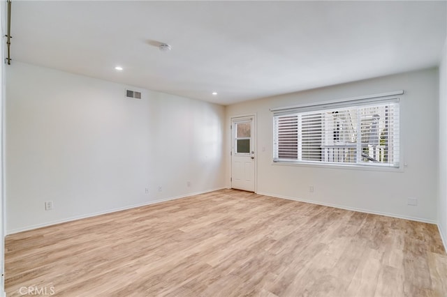 spare room with light hardwood / wood-style floors