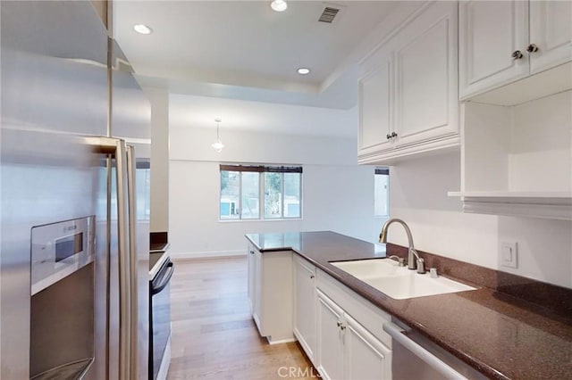 kitchen featuring recessed lighting, a sink, visible vents, white cabinets, and appliances with stainless steel finishes