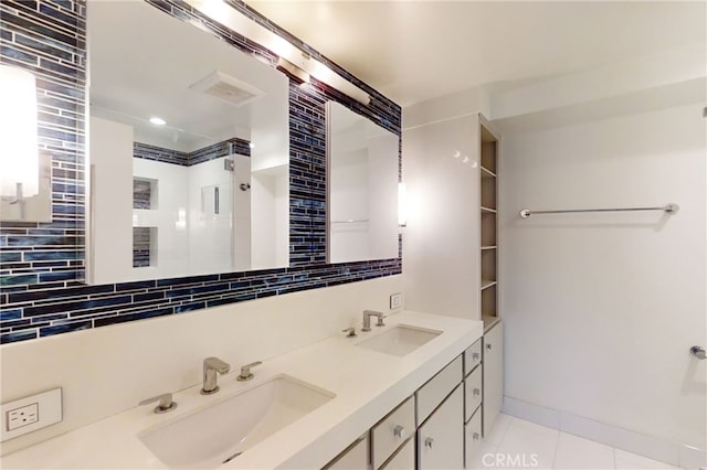 full bathroom featuring double vanity, tasteful backsplash, tile patterned flooring, and a sink