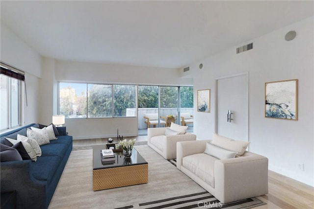 living area with light wood-type flooring and visible vents