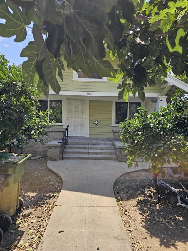 view of exterior entry featuring covered porch