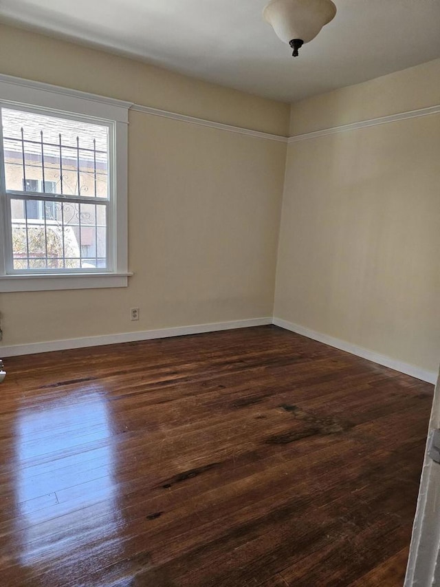 spare room featuring dark hardwood / wood-style floors