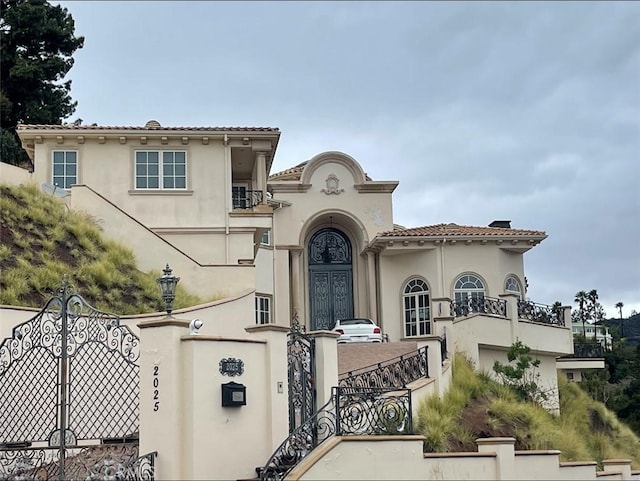 mediterranean / spanish home featuring a balcony