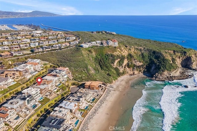 birds eye view of property featuring a water view and a beach view