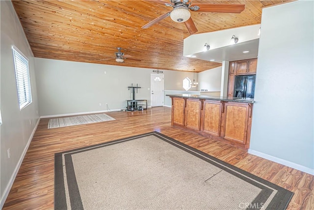 kitchen featuring black refrigerator with ice dispenser, hardwood / wood-style floors, and wooden ceiling