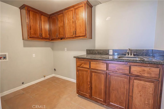 laundry area featuring sink, cabinets, washer hookup, hookup for a gas dryer, and light tile patterned floors