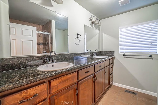 bathroom featuring tile patterned flooring, vanity, and an enclosed shower