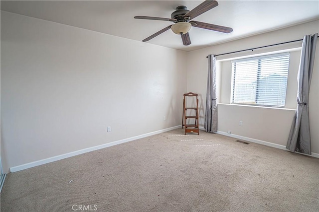 spare room featuring ceiling fan and light colored carpet