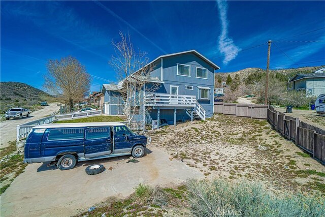 view of front of property with a deck with mountain view