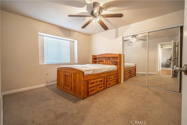 unfurnished bedroom featuring ceiling fan, a closet, and light carpet