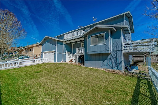 view of front of property with a balcony, a front lawn, and a garage