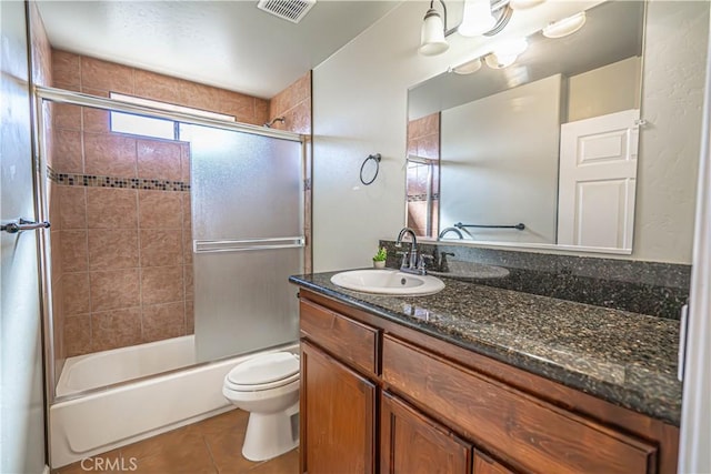 full bathroom with tile patterned floors, vanity, toilet, and combined bath / shower with glass door