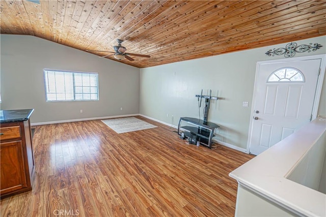 entrance foyer with lofted ceiling, wood ceiling, a wealth of natural light, and light hardwood / wood-style flooring