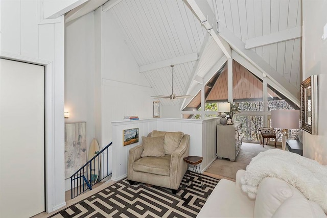 living room featuring beamed ceiling and high vaulted ceiling