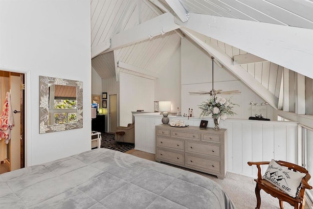 bedroom with light colored carpet, beam ceiling, and high vaulted ceiling