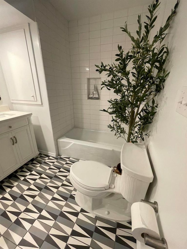 full bathroom featuring vanity, toilet, and tiled shower / bath