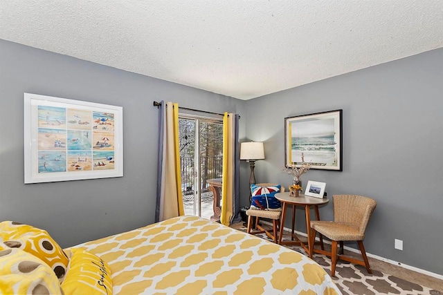 carpeted bedroom featuring a textured ceiling and access to outside