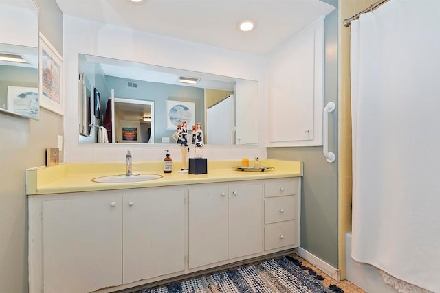 bathroom featuring shower / bathtub combination with curtain, tile patterned floors, and vanity