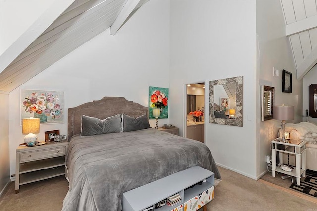 bedroom with high vaulted ceiling, connected bathroom, and light colored carpet