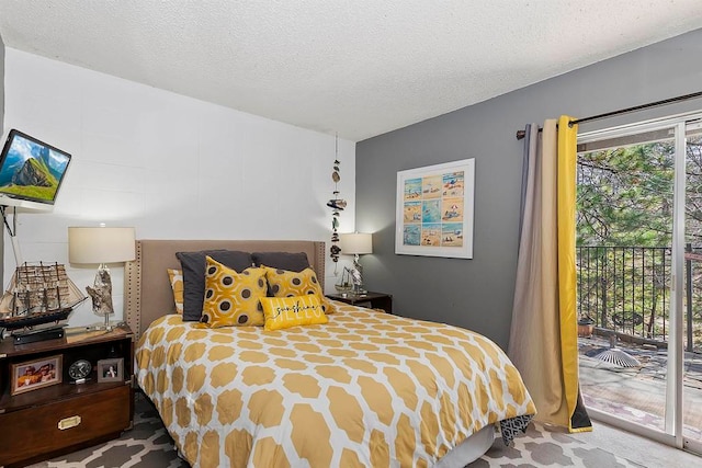 carpeted bedroom with a textured ceiling and access to exterior