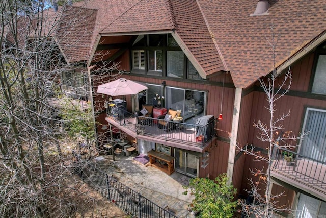 back of property featuring a balcony