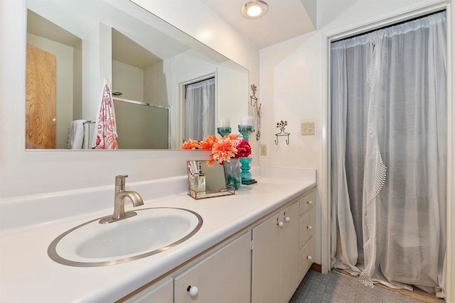 bathroom featuring vanity, tile patterned flooring, and curtained shower