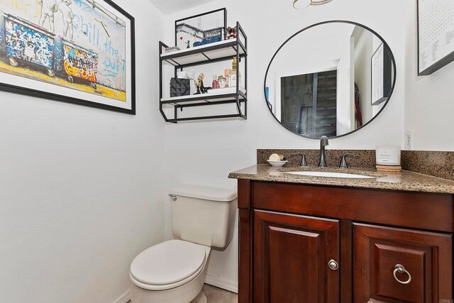 bathroom featuring vanity and toilet