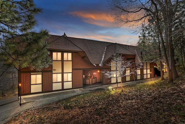 back house at dusk with a patio