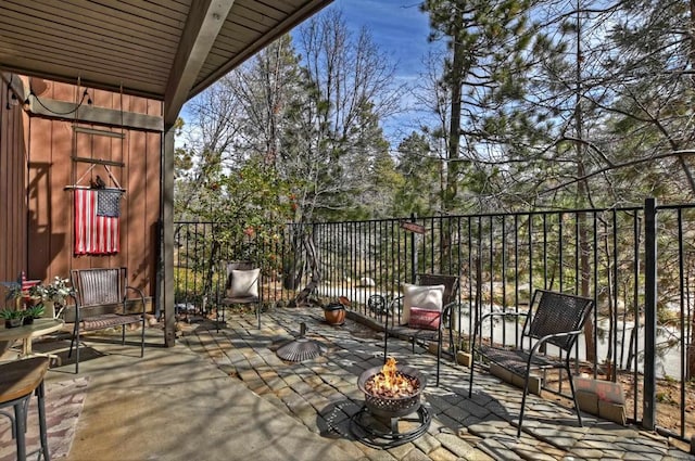 balcony with a patio and an outdoor fire pit