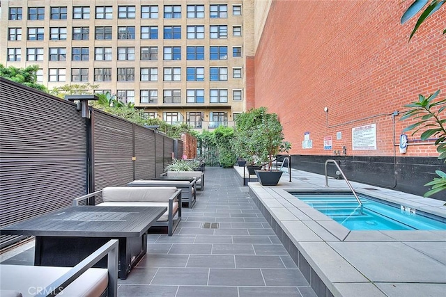 view of swimming pool with an in ground hot tub and a patio area