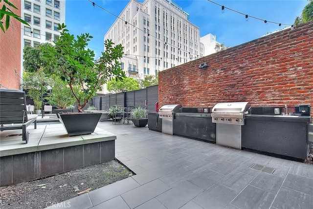 view of patio with area for grilling and exterior kitchen