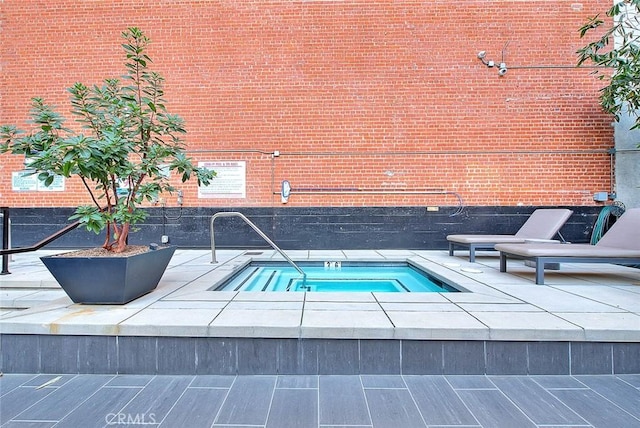 view of swimming pool featuring a hot tub