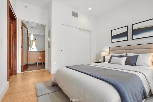 bedroom featuring a closet and light hardwood / wood-style floors