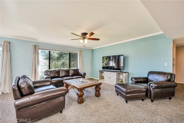 living room featuring carpet floors, a ceiling fan, and ornamental molding