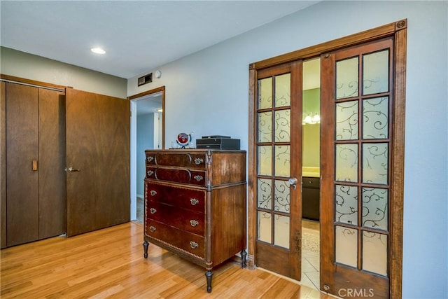 doorway to outside with french doors, recessed lighting, and wood finished floors