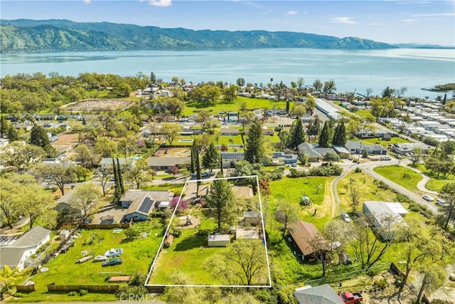 drone / aerial view with a residential view and a water and mountain view
