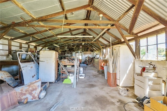 misc room featuring vaulted ceiling and concrete flooring