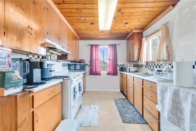 kitchen with plenty of natural light, tasteful backsplash, and wooden ceiling