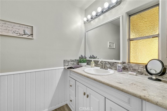 bathroom featuring vanity and tasteful backsplash